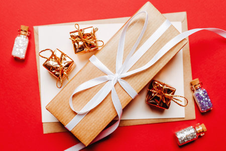 Christmas gift with toy on red isolated background. New Year conceptの写真素材