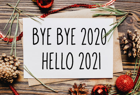 Merry christmas and merry new year concept with gift boxes, toys and notebook with text Bye bye 2020 Hello 2021の写真素材