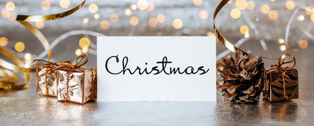Merry christmas and merry new year concept with gift boxes and greeting card with text Christmasの写真素材