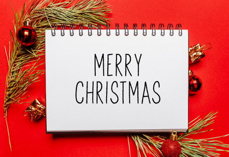merry christmas note with fir branch and toy on red isolated background. New Year conceptの写真素材