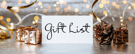 Merry christmas and merry new year concept with gift boxes and greeting card with text Gift Listの写真素材