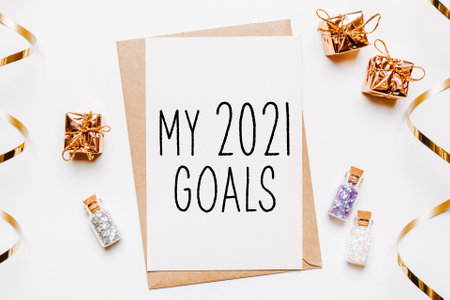 my 2021 goals note with envelope, gifts and gold glitter stars on white background. merry christmas and New Year conceptの写真素材