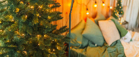 Christmas decorations at home. New year lights, toy, wreath and tree Noelの写真素材