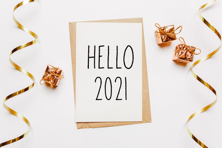 hello 2021 note with envelope, gifts and gold ribbon on white background. merry christmas and New Year conceptの写真素材