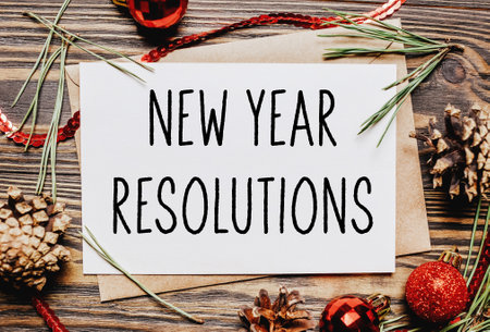 Merry christmas and merry new year concept notebook with text New Year Resolutionsの写真素材