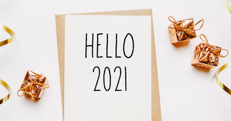 hello 2021 note with envelope, gifts and gold ribbon on white background. merry christmas and New Year conceptの写真素材