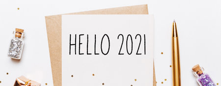 hello 2021 note with envelope, gifts and gold glitter stars on white background. merry christmas and New Year conceptの写真素材
