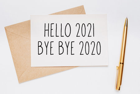 hello 2021 bye bye 2020 note with envelope and gold pen on white background. merry christmas and New...