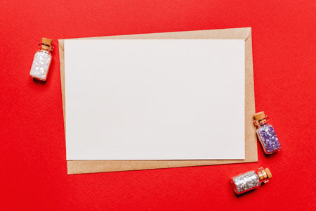 Blank christmas note with glitter toy on red isolated background. New Year conceptの写真素材