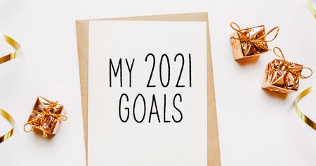Blamy 2021 goals nk note with envelope, gifts and gold ribbon on white background. merry christmas and New Year conceptの写真素材