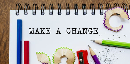 Make A Change text written on a paper with pencils in officeの写真素材