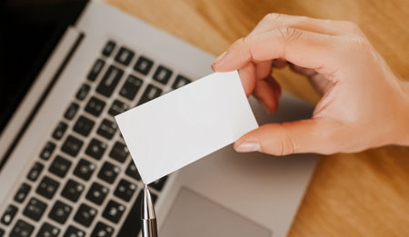 Man holding a business card with blank background in officeの写真素材