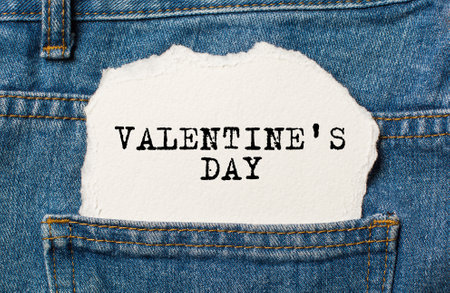 love on torn paper background on jeans love and valentine conceptの写真素材