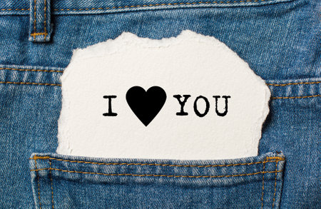 I love you on torn paper background on jeans love and valentine conceptの写真素材