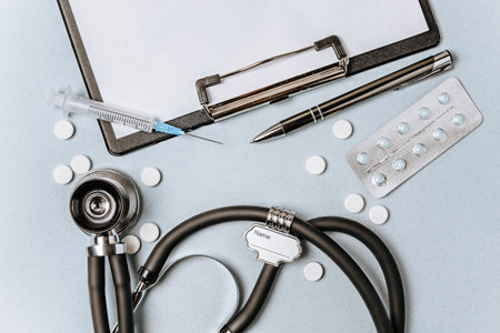 Medical concept with stethoscope, pills, notepad, pen on the doctor desktopの写真素材