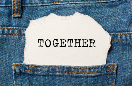 together on torn paper background on jeans love and valentine conceptの写真素材