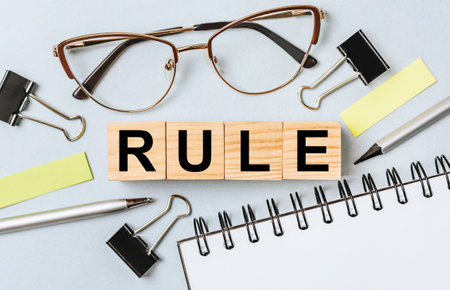 RULE word on wooden cubes on office deskの写真素材