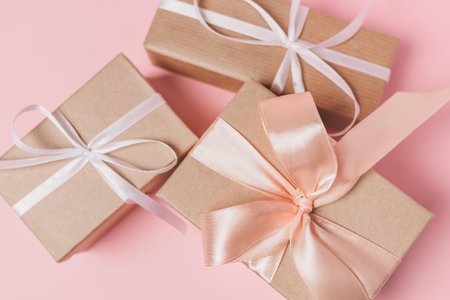 Gifts with wihte ribbon on isolated pink background, love and valentine conceptの写真素材