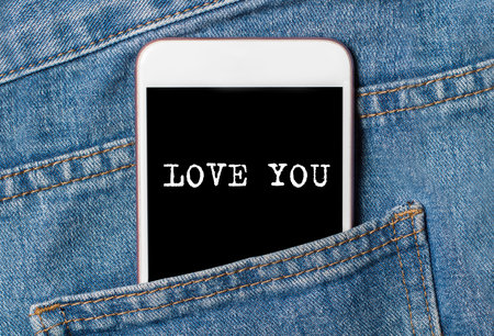 I love you on background phone on jeans love and valentine conceptの写真素材