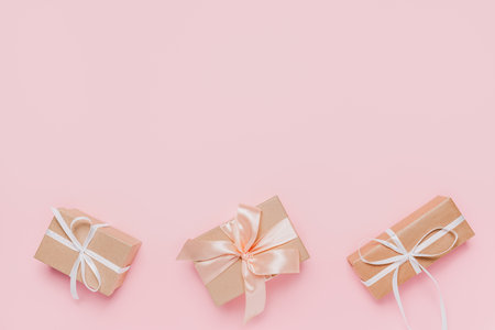 Gifts with wihte ribbon on isolated pink background, love and valentine conceptの写真素材