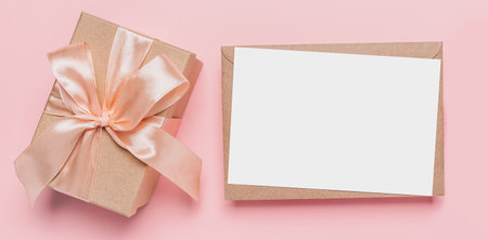 Gifts with note letter on isolated pink background, love and valentine conceptの写真素材