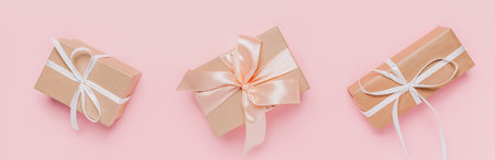 Gifts with wihte ribbon on isolated pink background, love and valentine conceptの写真素材