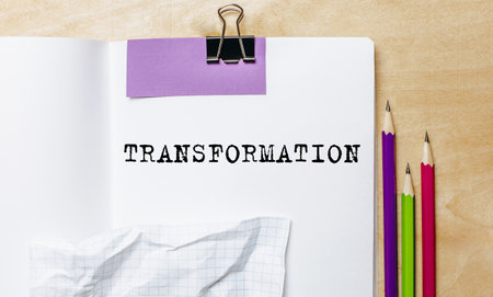 TRANSFORMATION text written on a paper with pencils on the desk in the officeの写真素材