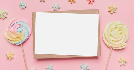 Gifts with note letter on isolated pink background with sweets, love and valentine conceptの写真素材