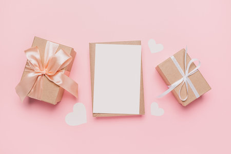 Gifts with note letter on isolated pink background, love and valentine conceptの写真素材