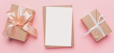 Gifts with note letter on isolated pink background, love and valentine conceptの写真素材