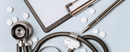 Medical concept with stethoscope, pills, notepad, pen on the doctor desktopの写真素材