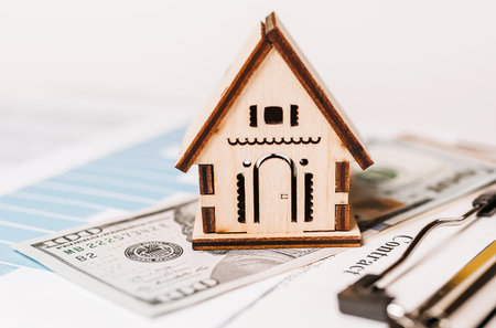 House miniature model and money on documents. Investment, real estate, home, housingの写真素材