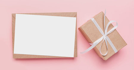 Gifts with note letter on isolated pink background, love and valentine conceptの写真素材