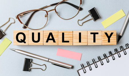 QUALITY word on wooden cubes on office deskの写真素材