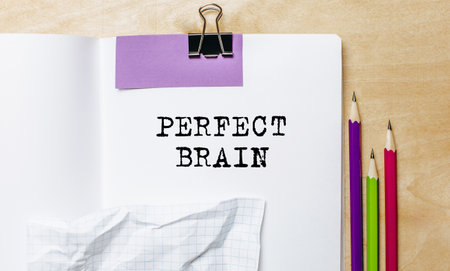 PERFECT BRAIN text written on a paper with pencils on the desk in the officeの写真素材