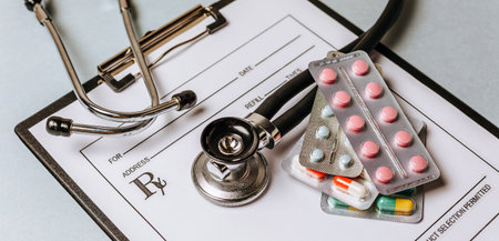 Medical concept with stethoscope, pills, notepad, pen on the doctor desktopの写真素材
