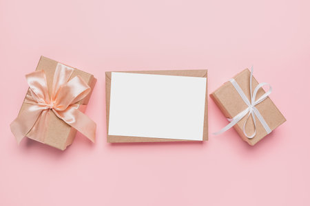 Gifts with note letter on isolated pink background, love and valentine conceptの写真素材