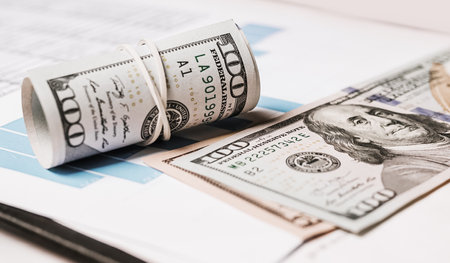 Money and business documents in the office. Investments, taxes, earnings, payments, finance conceptの写真素材