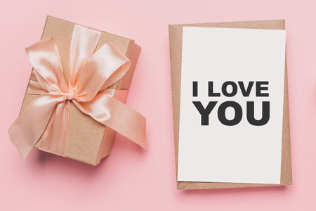 Gifts with note letter on isolated pink background, love and valentine concept with text I love youの写真素材