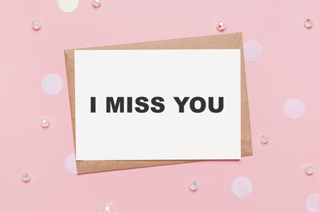 Gifts with note letter on isolated pink background, love and valentine concept with text I miss youの写真素材