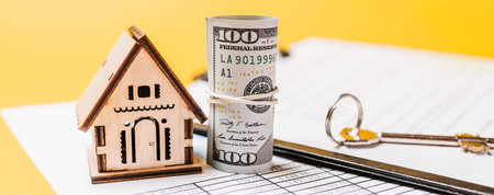 House miniature model and money on documents. Investment, real estate, home, housingの写真素材