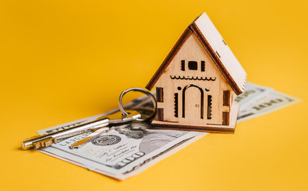 House miniature model, keys and money on a yellow background. Investment, real estate, home, housingの写真素材