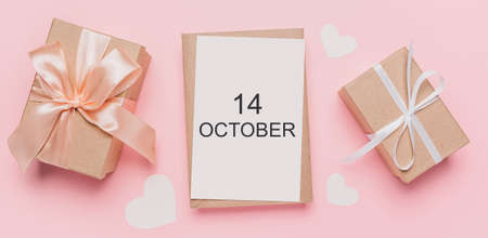 Gifts with note letter on isolated pink background, love and valentine concept with text 14 Octoberの写真素材