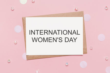 Gifts with note letter on isolated pink background, love and valentine concept with text International Womens Dayの写真素材