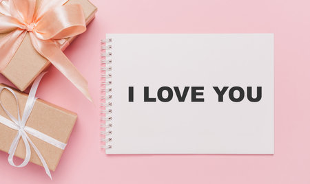 Gifts with note letter on isolated pink background, love and valentine concept with text I love youの写真素材