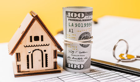 House miniature model and money on documents. Investment, real estate, home, housingの写真素材