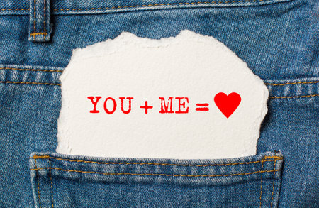 you and me on torn paper background on jeans love and valentine conceptの写真素材