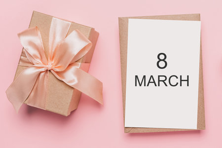 Gifts with note letter on isolated pink background, love and valentine concept with text 8 marchの写真素材