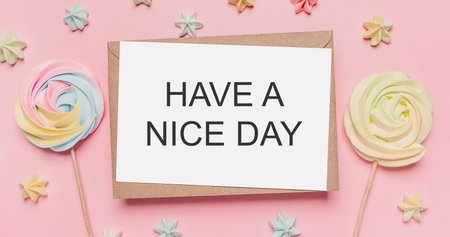 Gifts with note letter on isolated pink background with sweets, love and valentine concept with text HAVE A NICE DAYの写真素材