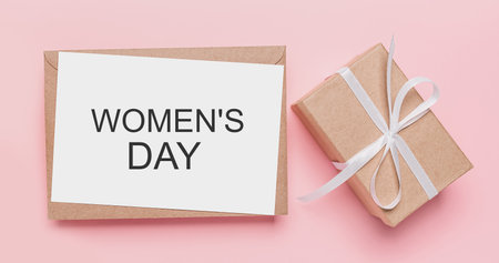 Gifts with note letter on isolated pink background, love and valentine concept with text Womens Dayの写真素材